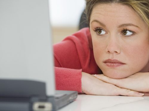 Woman sad at computer